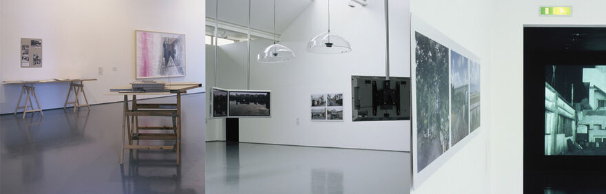 Selected images from Behind Closed Doors at DCA Galleries. One image shows tables with pictures on them. There is also a large framed abstract painting with pink and black in it. In another image, lights hang from the ceiling, along with flat-screen televisions with black-and-white pictures of buildings on them. In another image, there is a framed picture of foliage and buildings. Through a door, a dark image of an industrial building can be seen.