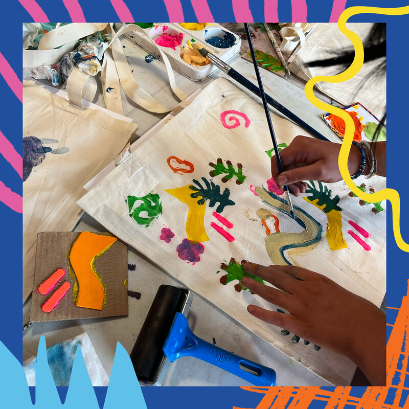 Pupil from Banchory Academy painting a design on a tote bag