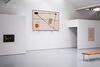 A gallery space with a large fabric banner featuring the Tay Bridge