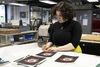 Katriona Gillon signing screenprints of Dundead 2025 design with red detail