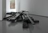 From Jutta Koether's exhibition. Black wood, driftwood and glass lie on DCA floors in a state of disarray.